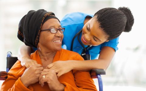 african senior patient with female nurse