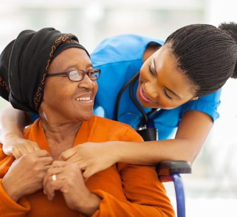 african senior patient with female nurse happy senior patient with friendly female nurse